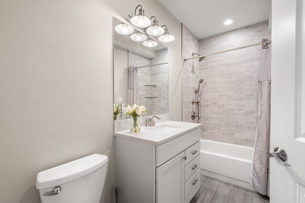 25 Cherry Street, Unit 3 Danvers, MA 01923 - Photo 20 of 27 a bathroom with a sink a toilet and shower
