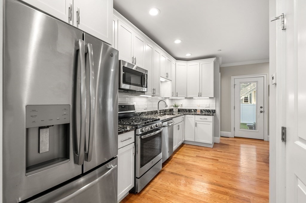 25 Cherry Street, Unit 3 Danvers, MA 01923 - Photo 2 of 27 a kitchen with stainless steel appliances a refrigerator sink and stove