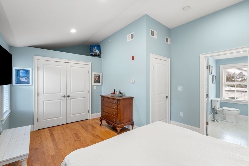 25 Cherry Street, Unit 3 Danvers, MA 01923 - Photo 22 of 27 a bedroom with a bed and wooden floor