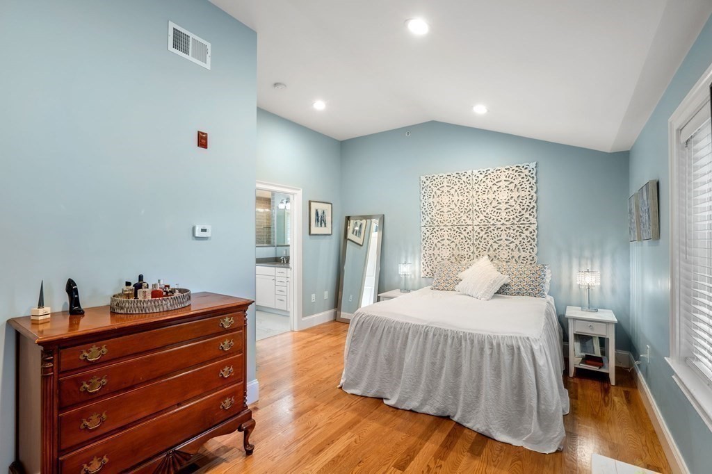 25 Cherry Street, Unit 3 Danvers, MA 01923 - Photo 23 of 27 a bedroom with a bed and a night stand