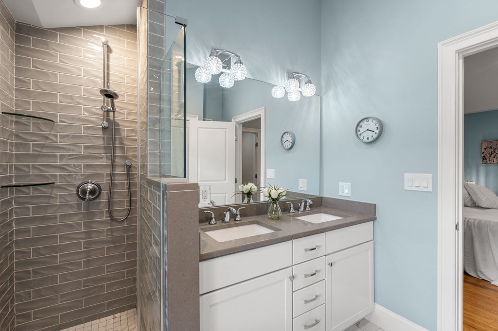 25 Cherry Street, Unit 3 Danvers, MA 01923 - Photo 25 of 27 a bathroom with a granite countertop sink a mirror and shower