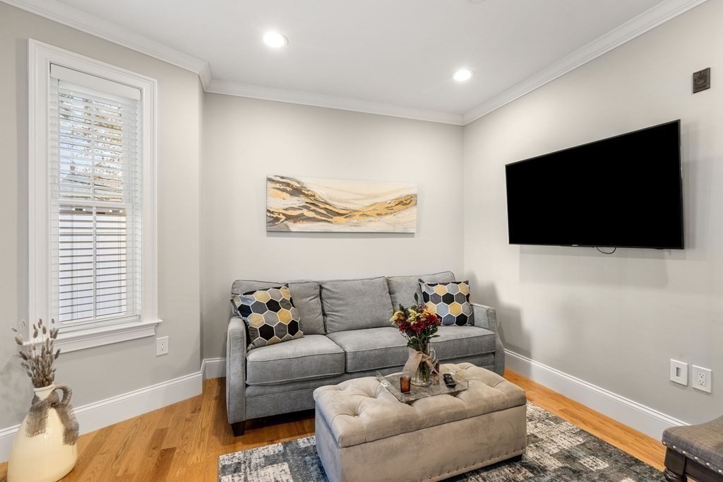 25 Cherry Street, Unit 3 Danvers, MA 01923 - Photo 10 of 27 a living room with furniture and a flat screen tv