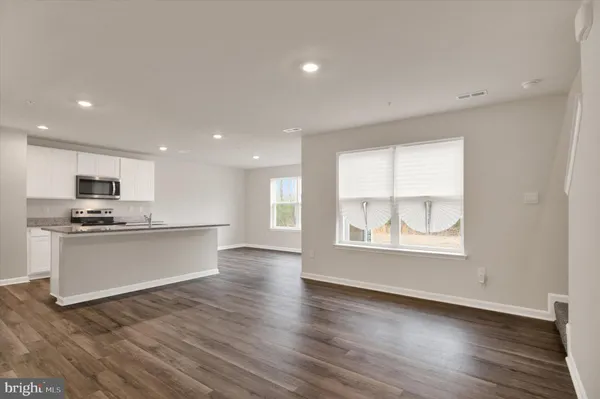 a view of kitchen with wooden floor and windows
