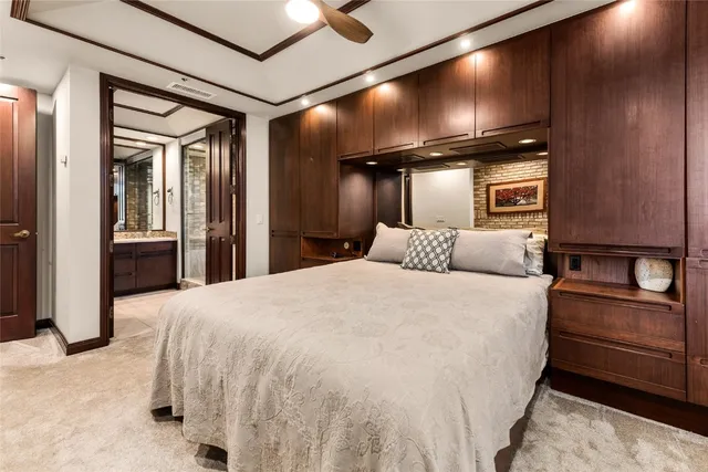 a bedroom with a bed and lamp with the walls