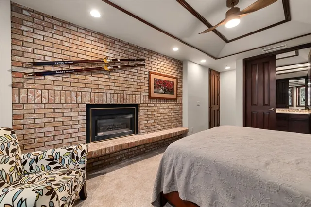 a spacious bedroom with a bed and a fireplace