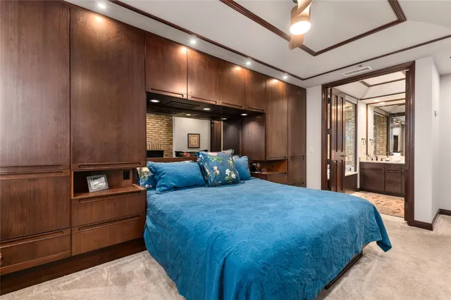 a large bedroom with a bed and glass wall