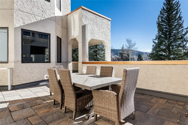 a view of a patio with table and chairs and potted plants