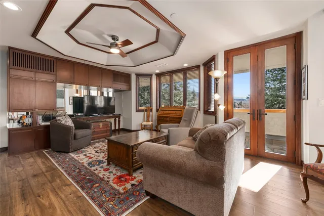 a living room with furniture and a floor to ceiling window