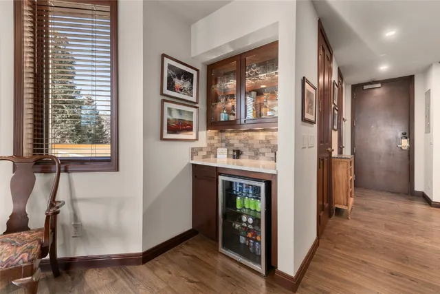 a open kitchen with windows and refrigerator