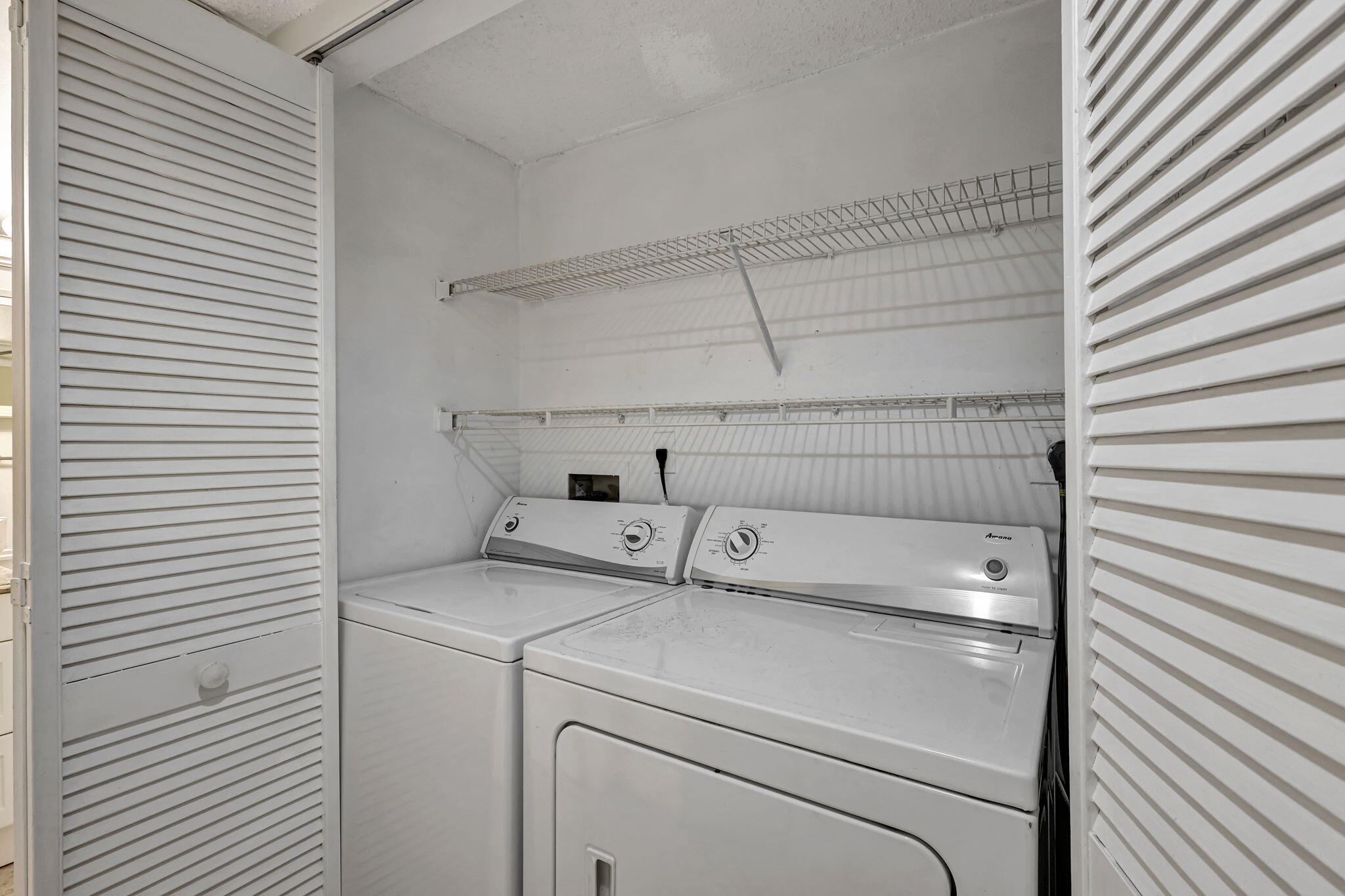 320 Northwest 67th Street, Unit C207 Boca Raton, FL 33487 - Photo 13 of 39 a utility room with dryer and washer