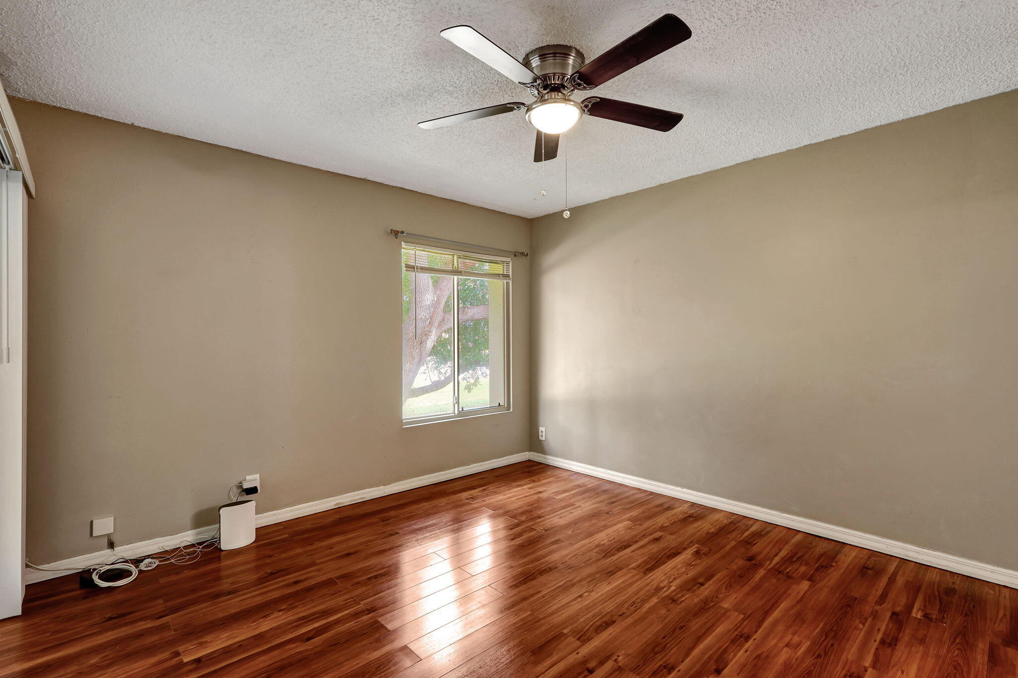320 Northwest 67th Street, Unit C207 Boca Raton, FL 33487 - Photo 15 of 39 wooden floor in an empty room with a window