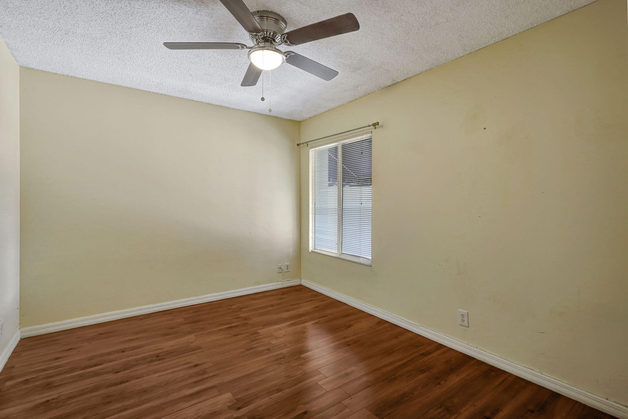 320 Northwest 67th Street, Unit C207 Boca Raton, FL 33487 - Photo 2 of 39 an empty room with wooden floor and windows