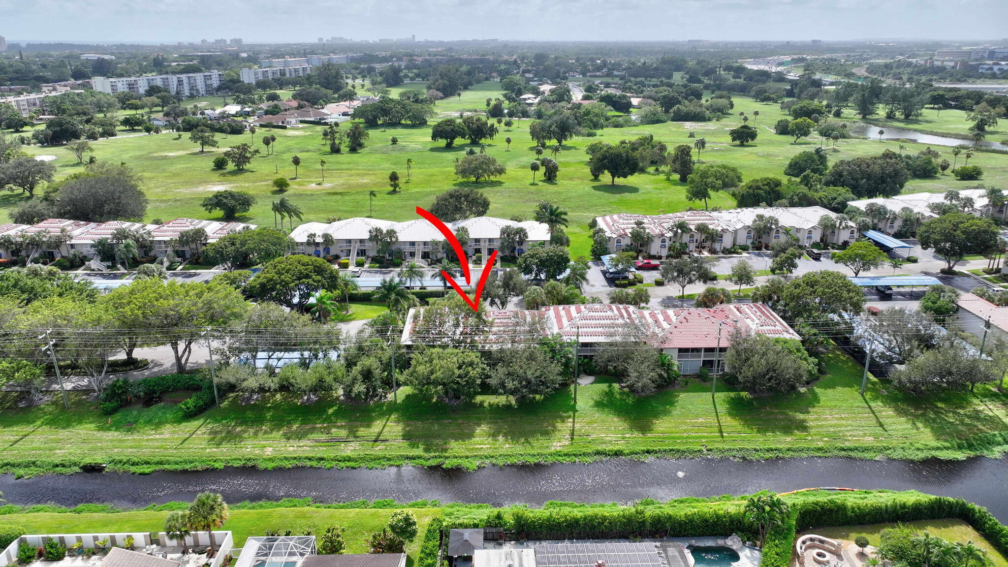 320 Northwest 67th Street, Unit C207 Boca Raton, FL 33487 - Photo 34 of 39 an aerial view of a house with a yard and lake view
