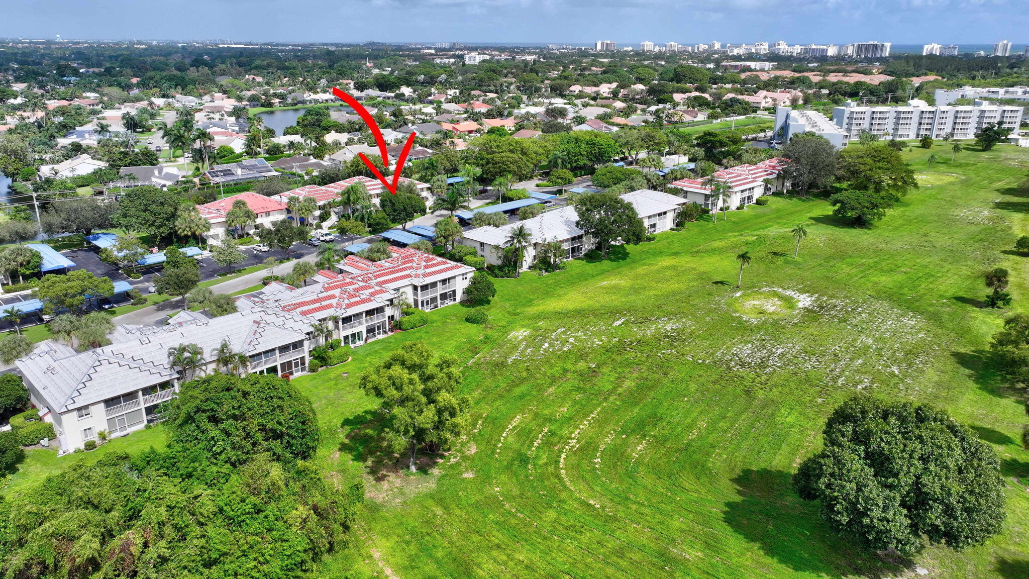 320 Northwest 67th Street, Unit C207 Boca Raton, FL 33487 - Photo 38 of 39 an aerial view of residential houses with outdoor space and trees