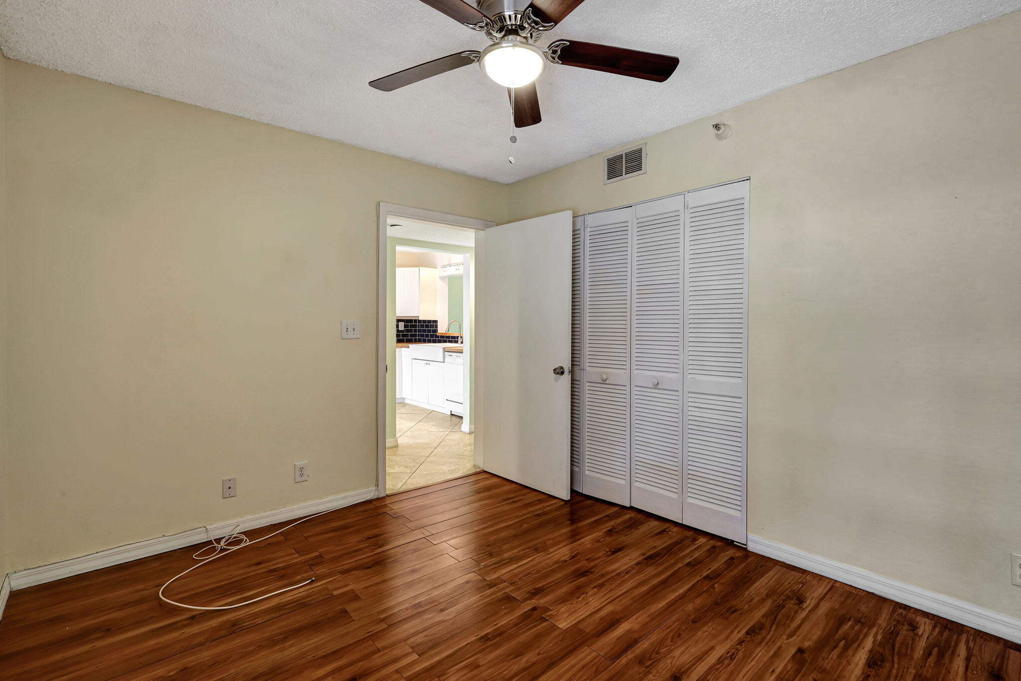 320 Northwest 67th Street, Unit C207 Boca Raton, FL 33487 - Photo 4 of 39 wooden floor in an empty room with a window