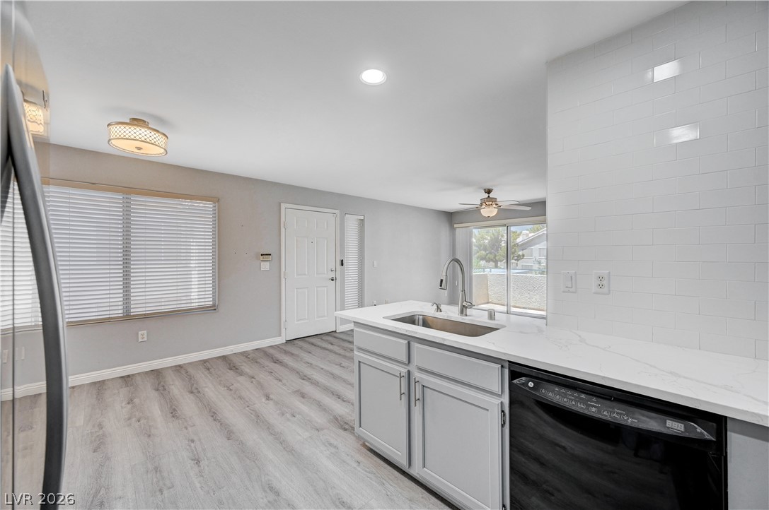 3425 East Russell Road, Unit 223 Las Vegas, NV 89120 - Photo 10 of 47 A well-appointed kitchen island featuring a modern sink, perfect for culinary endeavors and casual dining.