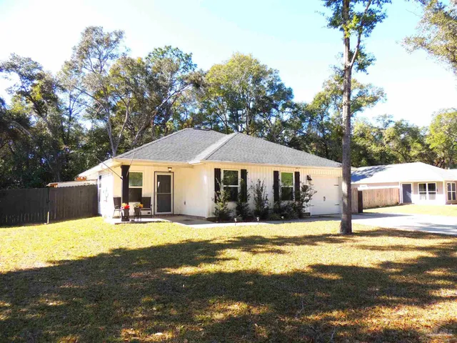a front view of a house with swimming pool yard and patio
