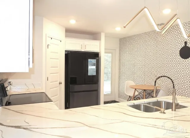 a bedroom with a bed and a dresser with washing machine