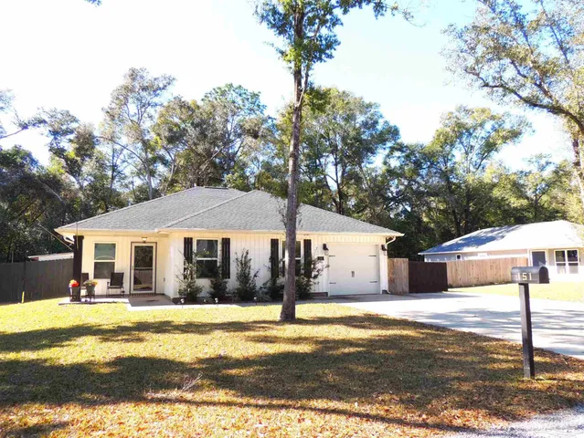 a front view of a house with swimming pool and porch