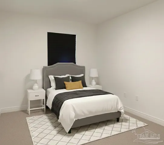 a bedroom with a bed and a lamp