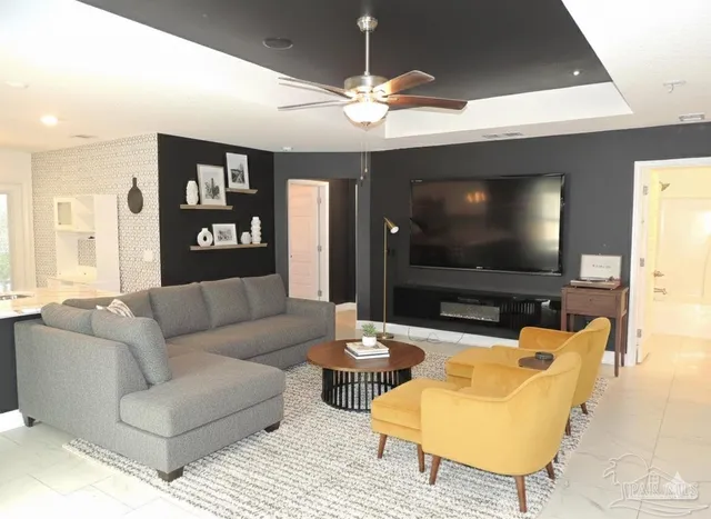 a living room with furniture and a flat screen tv