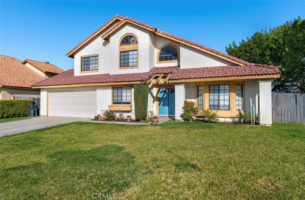 993 South Date Avenue Rialto, CA 92376 - Photo 2 of 27 a front view of a house with a garden