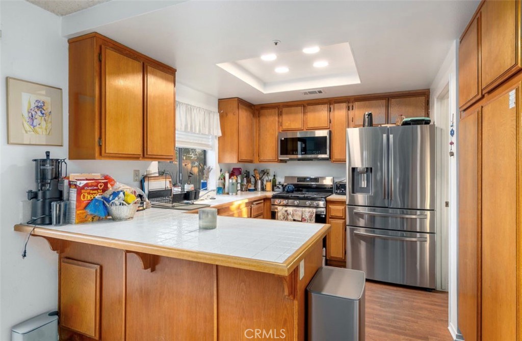 993 South Date Avenue Rialto, CA 92376 - Photo 22 of 27 a kitchen with a sink a refrigerator and wooden floor