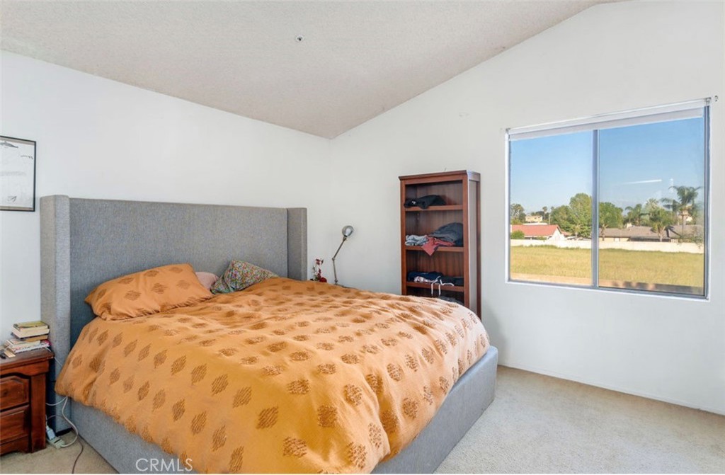 993 South Date Avenue Rialto, CA 92376 - Photo 24 of 27 a bed sitting in a bedroom next to a window