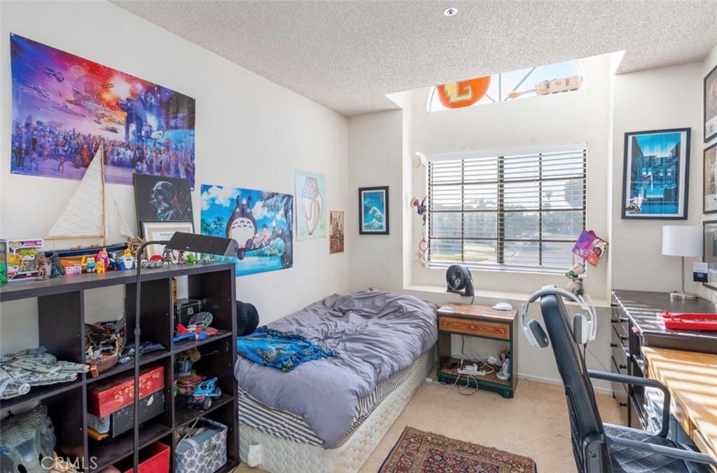 993 South Date Avenue Rialto, CA 92376 - Photo 26 of 27 a bedroom with furniture a flat screen tv and a window