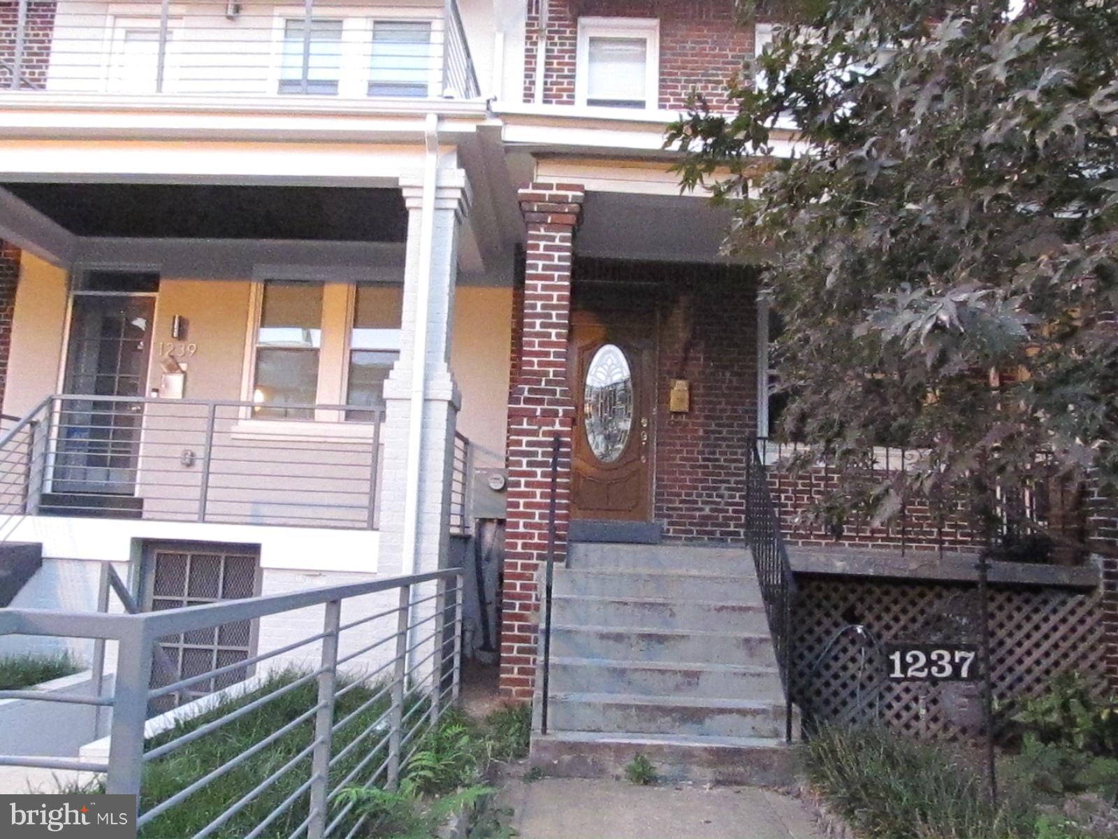 1237 Oates Street Northeast Washington, DC 20002 - Photo 1 of 15 a front view of a house with a yard