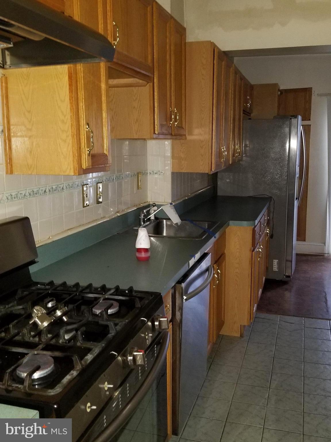 1237 Oates Street Northeast Washington, DC 20002 - Photo 7 of 15 a kitchen with a stove and a refrigerator