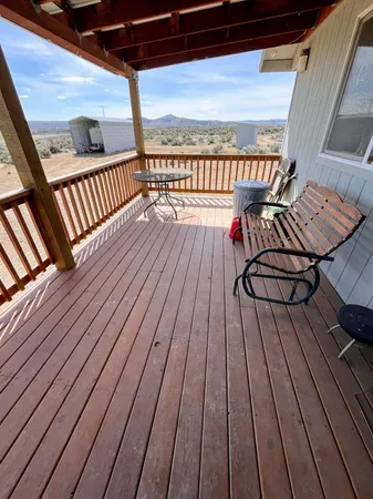 a view of balcony with wooden floor and bench