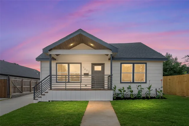 a front view of a house with a garden