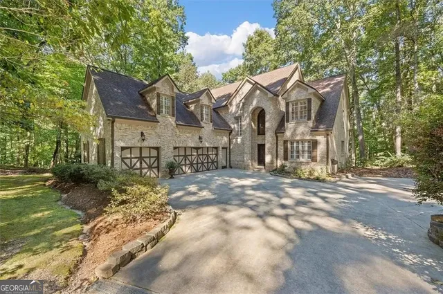 a view of a house with a yard and pathway