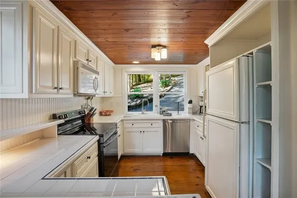 a kitchen with a white cabinets and white appliances