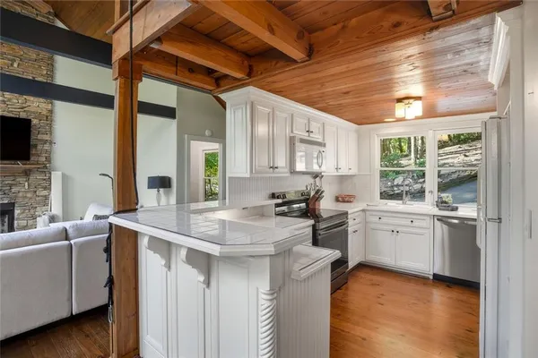 a kitchen with sink stove and cabinets