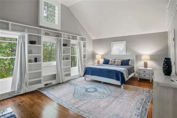 a bedroom with a large bed and a window