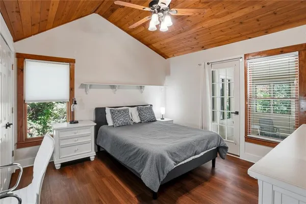 a bedroom with a large bed and a chandelier