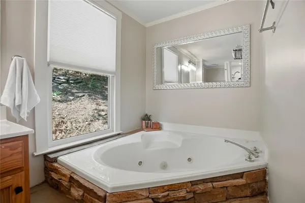 a bathroom with a tub and a window