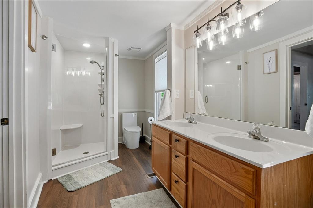 203 Wild Azalea Circle Jasper, GA 30143 - Photo 28 of 37 a bathroom with a sink double vanity and a shower