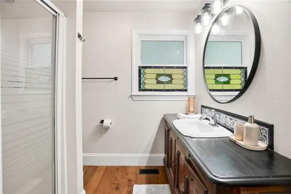 a bathroom with a sink a mirror and a window