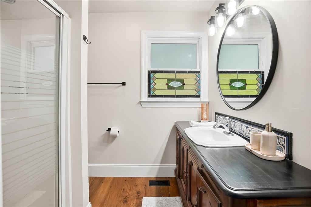 203 Wild Azalea Circle Jasper, GA 30143 - Photo 30 of 37 a bathroom with a sink a mirror and a window