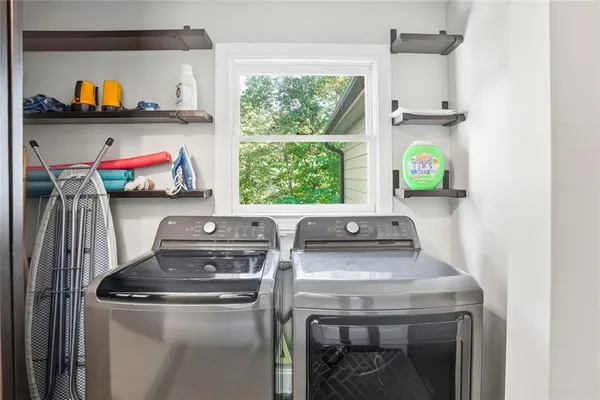 a view of washer and dryer with rug