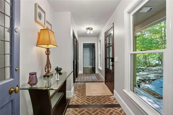 a view of hallway with furniture and a window