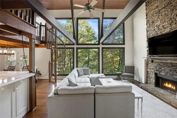 a living room with furniture a fireplace and a flat screen tv