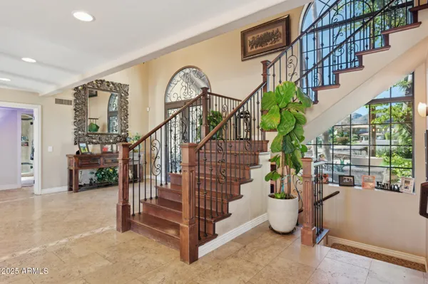 a living room with furniture a fireplace and a dining table with kitchen view