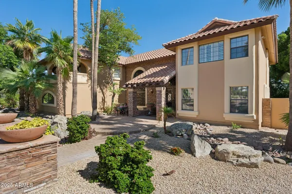 a dining room with furniture and large windows