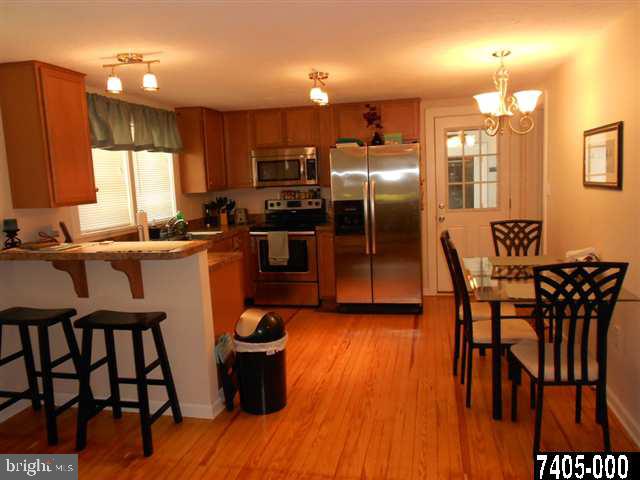 2100 Conewago Road Dover, PA 17315 - Photo 7 of 20 a kitchen with stainless steel appliances wooden floor dining table and chairs