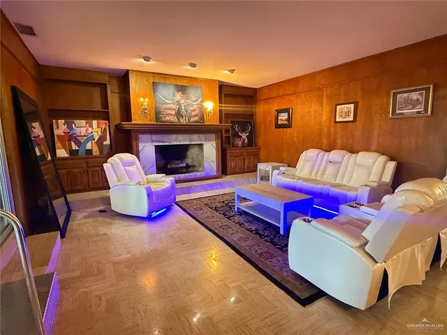 a view of an empty room with a fireplace and a window
