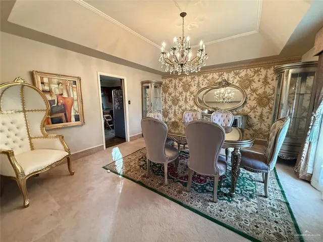 a view of a dining room with furniture and a chandelier